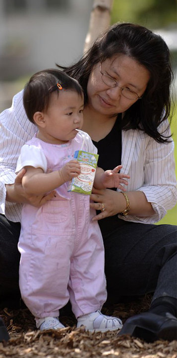 woman with infant drinking juice