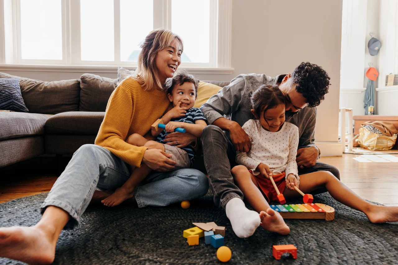 Family playing together in living room.